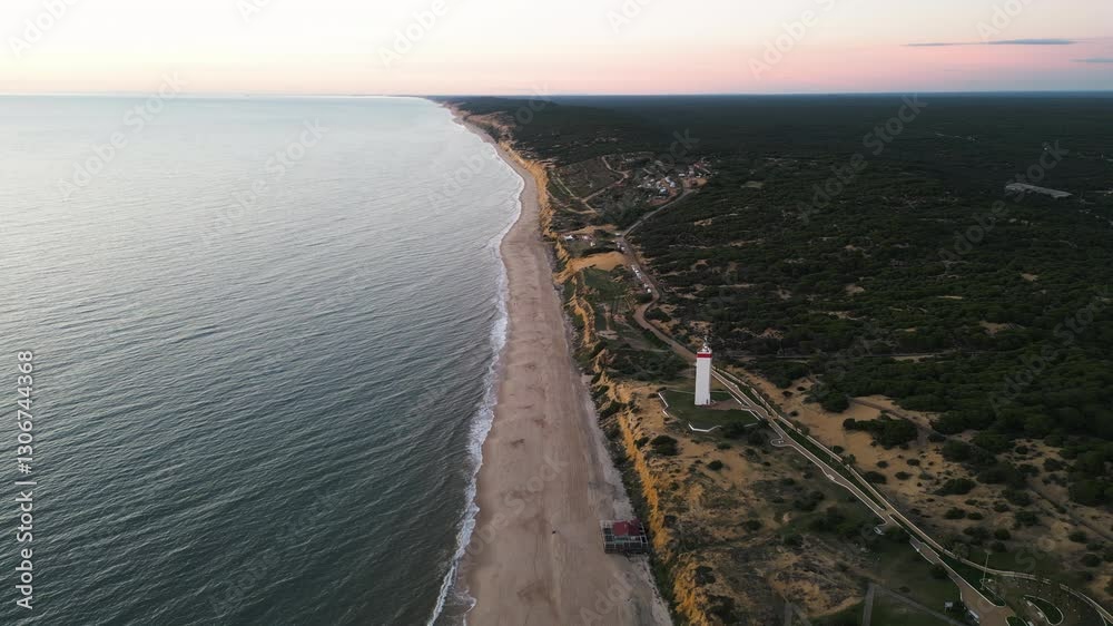 Endless Spain coastline and white lighthouse, aerial drone view Endless Spain coastline and white lighthouse, aerial drone view