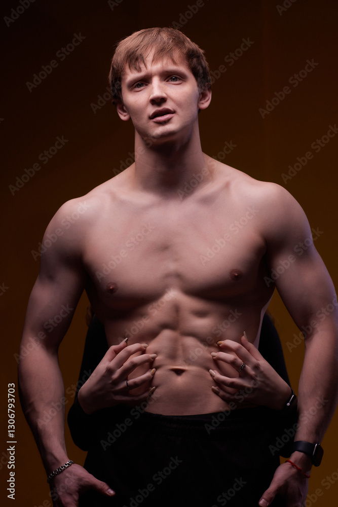 Naklejka premium Artistic Pose Displaying a Muscular Male Model That Exudes Strength and Confidence