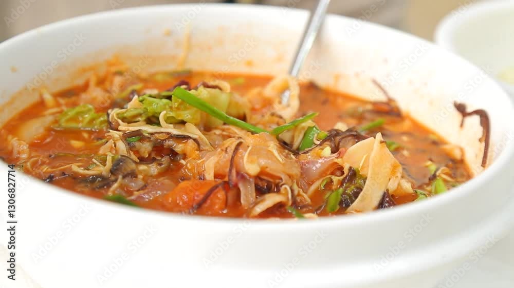 Stirring cold raw fish soup with chopsticks Stirring cold raw fish soup with chopsticks