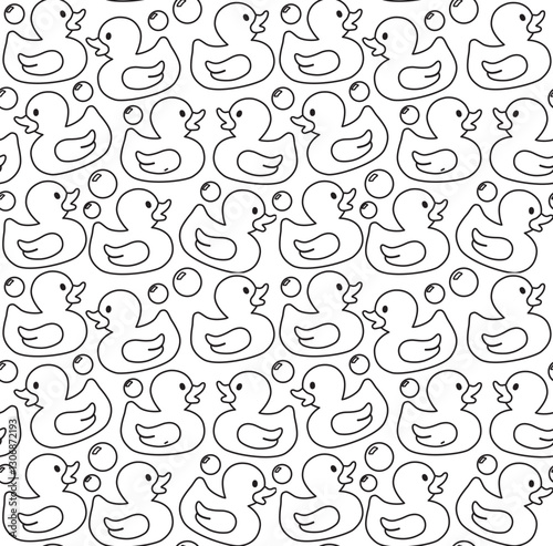 Seamless pattern with rubber ducks and soap bubbles. Background with bath toys in doodle style