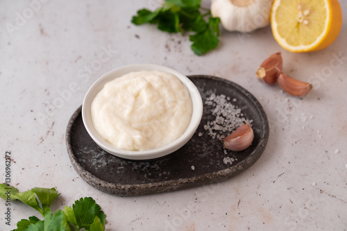 Lebanese Garlic sauce Toum or Salsat toum contains garlic, salt, olive oil and lemon juice. Traditional Middle East food. Food photography.