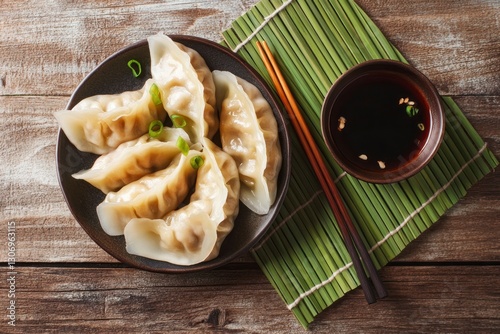 Serving of Steamed Asian Dumplings with Soy Sauce and Chopsticks