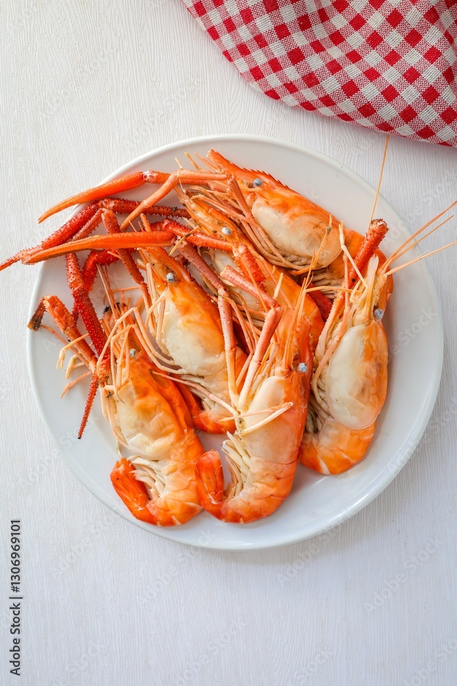 Boiled prawn in white ceramic plate on white background , top view food table with free copy space Boiled prawn in white ceramic plate on white background , top view food table with free copy space