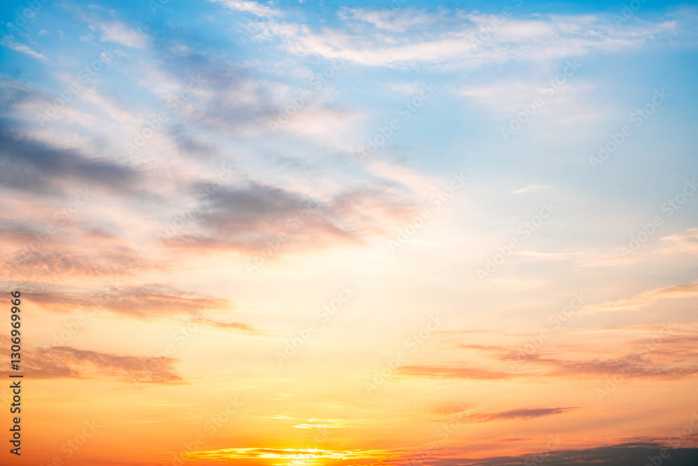 Fototapeta premium Sky,sunset, beautiful , luxury soft gradient orange gold clouds and sunlight on the blue sky perfect for the background, Sunrise on morning or everning in winter warm time ,Twilight summer,silhouette