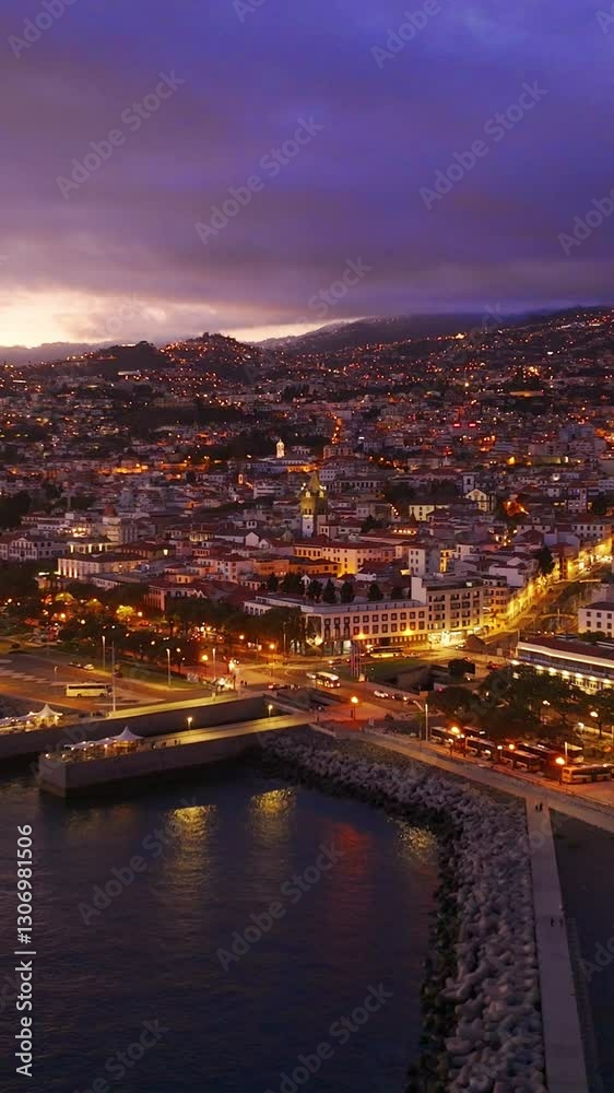Aaerial view of the vibrant city Funchal at twilight. Vertical video Aaerial view of the vibrant city Funchal at twilight. Vertical video