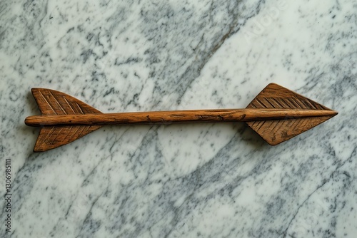 Wooden Arrow Replica Displayed on Marble Surface With Detailed Carving