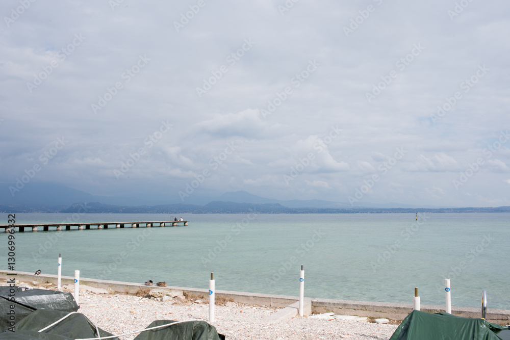 Obraz premium Beautiful aerial view of Garda Lake, wooden pier. No people