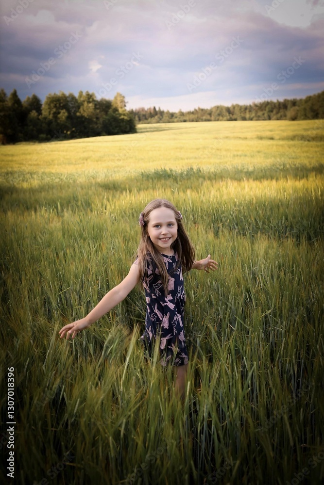 A child runs across the field. Spring/summer photo. Happy childhood, happiness and laughter. Concept of the photo - mother's day, children's day. A child runs across the field. Spring/summer photo. Happy childhood, happiness and laughter. Concept of the photo - mother's day, children's day.