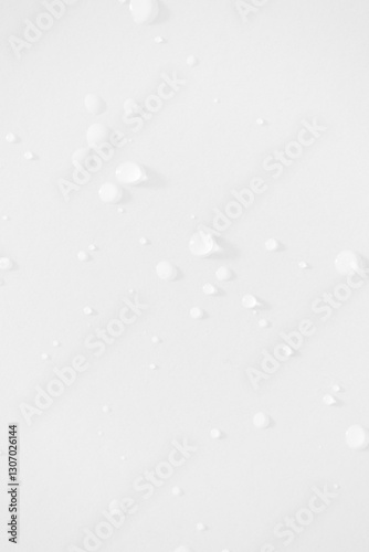 Water drops minimal white background vertical. Moisturizing and hydrating skincare beauty product concept