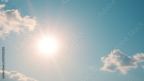 Bright sun shining in a clear blue sky with scattered clouds, conveying warmth, clarity, and a sense of open space