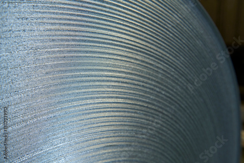 Galvanized steel coil detail and factory background.