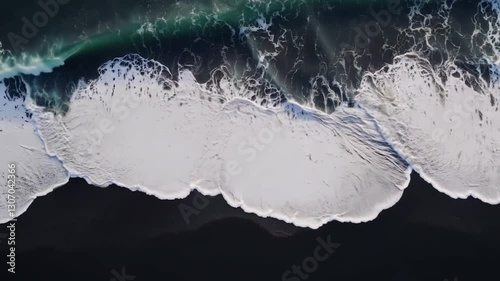 Sea waving top view black sand beach