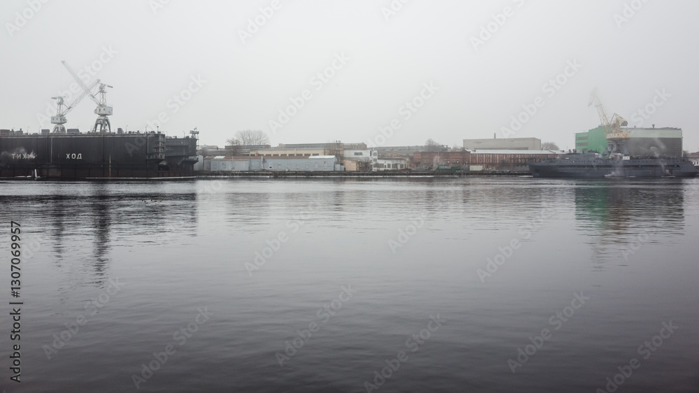 A serene view of a harbor showcasing industrial ships, structures A serene view of a harbor showcasing industrial ships, structures
