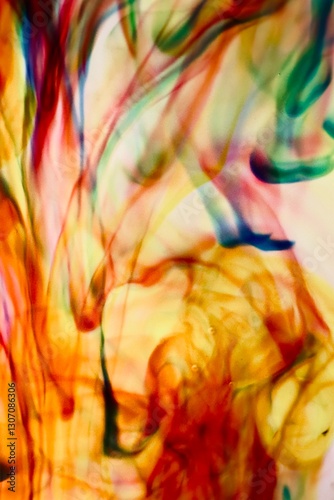 Abstract video with vibrant colors flowing with colored inks dispersed in water. The composition consists of shades of blue, red, green and yellow blending and swirling on a light background, creating