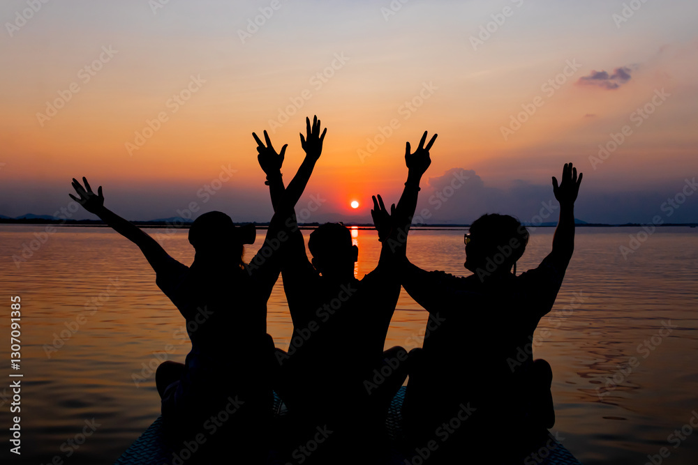 Fototapeta premium Rear view of three friends watching the sunset. 