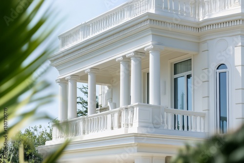 Close-up full view of modern white villa with detailed architecture and refined summer garden

