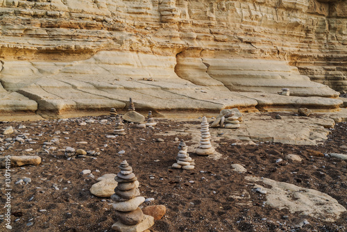 Photography Balanced Stone Cairns on a Rocky Beach at Sunset