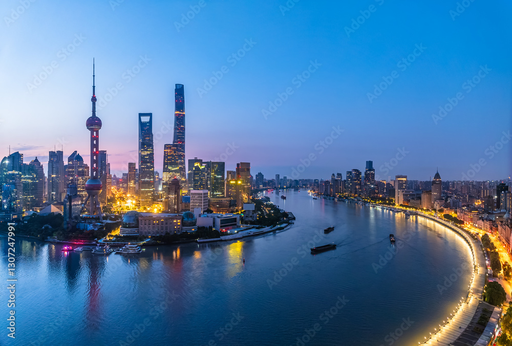 Naklejka premium Shanghai skyline at dusk with Huangpu River and illuminated cityscape, China