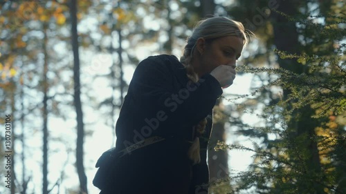Blonde-Haired Woman Touching a Pine Tree Branch in an Autumn Forest in the Morning 4K 
