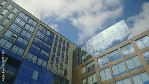 Low Angle View of Modern Glass Buildings with Blue Sky and White Clouds 4K