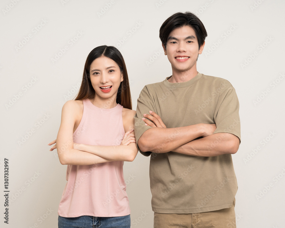 Happy asian couple attractive in various action gesture standing on isolated white background. Cheerful Smiling young man and woman arms crossed Happy asian couple attractive in various action gesture standing on isolated white background. Cheerful Smiling young man and woman arms crossed