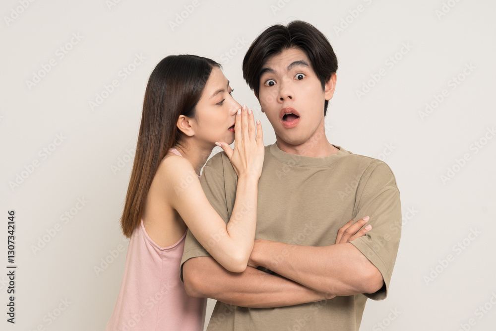 Whispering some secret gossip.Happy asian couple attractive in various action gesture standing on isolated white background. Cheerful Smiling young man and woman whispering some secret gossip. Whispering some secret gossip.Happy asian couple attractive in various action gesture standing on isolated white background. Cheerful Smiling young man and woman whispering some secret gossip.