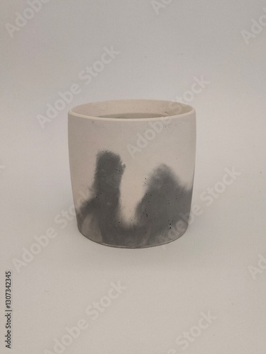 A round concrete tray with an abstract gray and white pattern on a neutral white background.