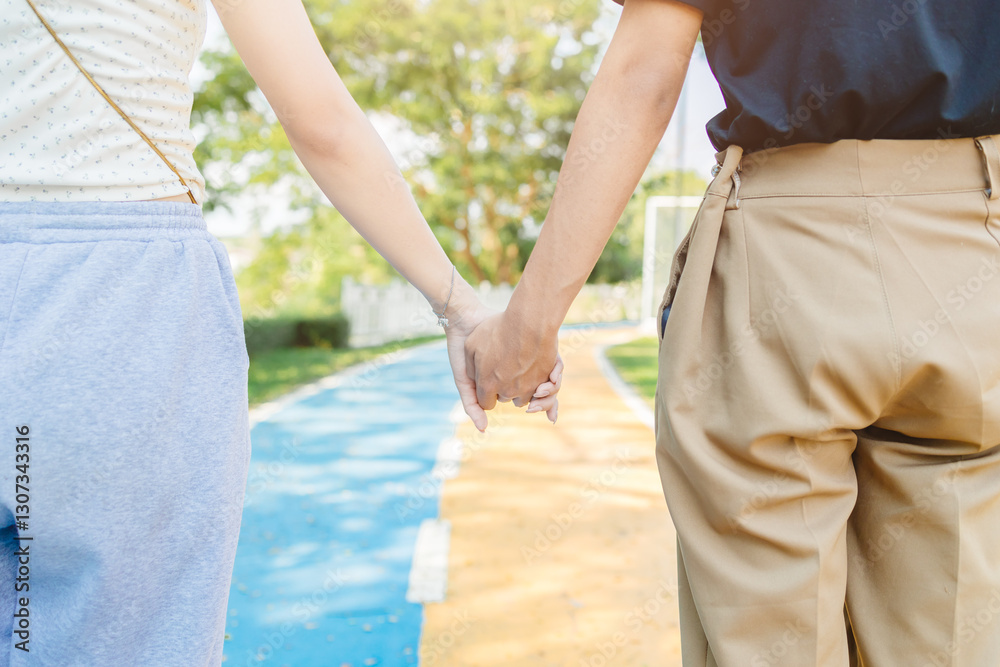 closeup man and women hand holding together at center road line for future living of lover concept closeup man and women hand holding together at center road line for future living of lover concept