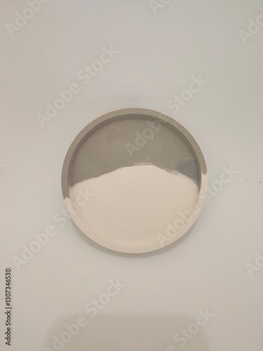 A stylish concrete round tray with a dual-tone finish, blending natural gray and white hues. Perfect for modern home decor.