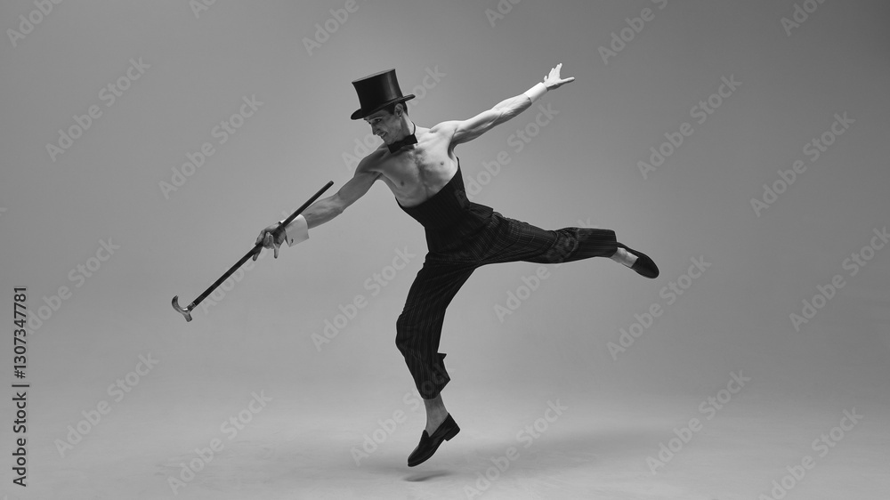 Dynamic performer in high-waisted corset and classic top hat jumping gracefully with expressive arms in monochrome photo filter. Concept of vintage time, art, music, elegance, charisma. Dynamic performer in high-waisted corset and classic top hat jumping gracefully with expressive arms in monochrome photo filter. Concept of vintage time, art, music, elegance, charisma.