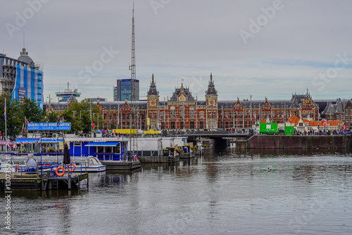 Photography Beautiful aerial view of  Amsterdam Centraal Train Station and its historic hub with canals, bikes, cafes