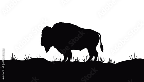 Silhouette of a buffalo grazing on grassy landscape