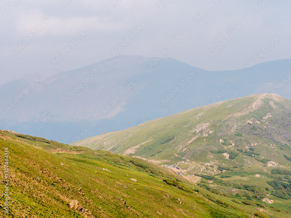 Fototapeta premium Vibrant mountain landscape images with bright greens and blues of the Rocky Mountains. Focus on the foreground.