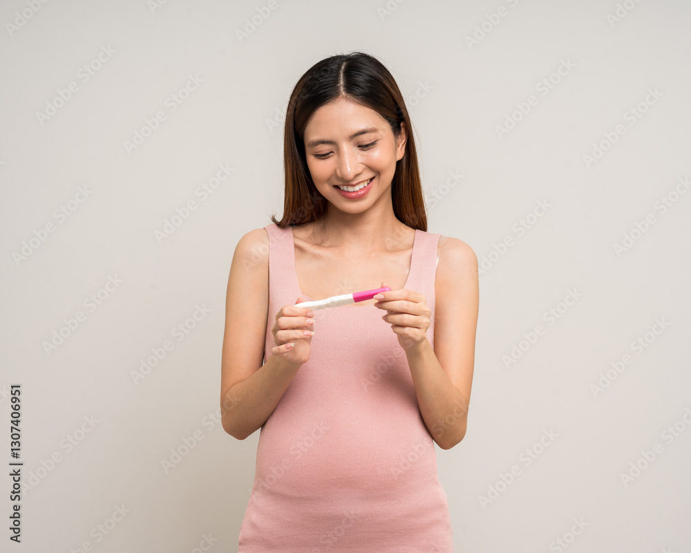 Happy Pregnant asian woman stroking touch belly motherhood with pregnancy test on isolated background. Family planning maternity and pregnancy health. Happy Pregnant asian woman stroking touch belly motherhood with pregnancy test on isolated background. Family planning maternity and pregnancy health.