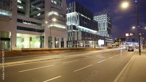 Modern houses and skyscrapers in Casablanca at night. Frantic rhythm of city. Traffic on the night highway. Morocco	