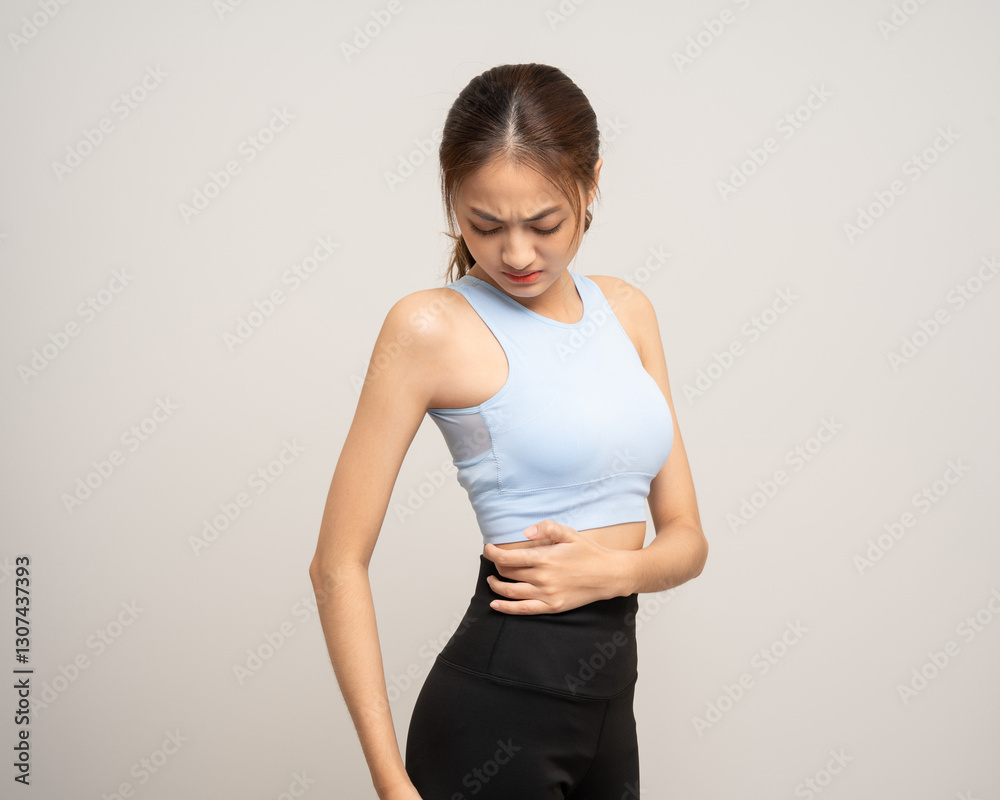 Young sporty asian woman has inflamed back ache because she is workout exercise too much. Accident suffering while training workout. She massage to soothe and relax on isolated background. Young sporty asian woman has inflamed back ache because she is workout exercise too much. Accident suffering while training workout. She massage to soothe and relax on isolated background.