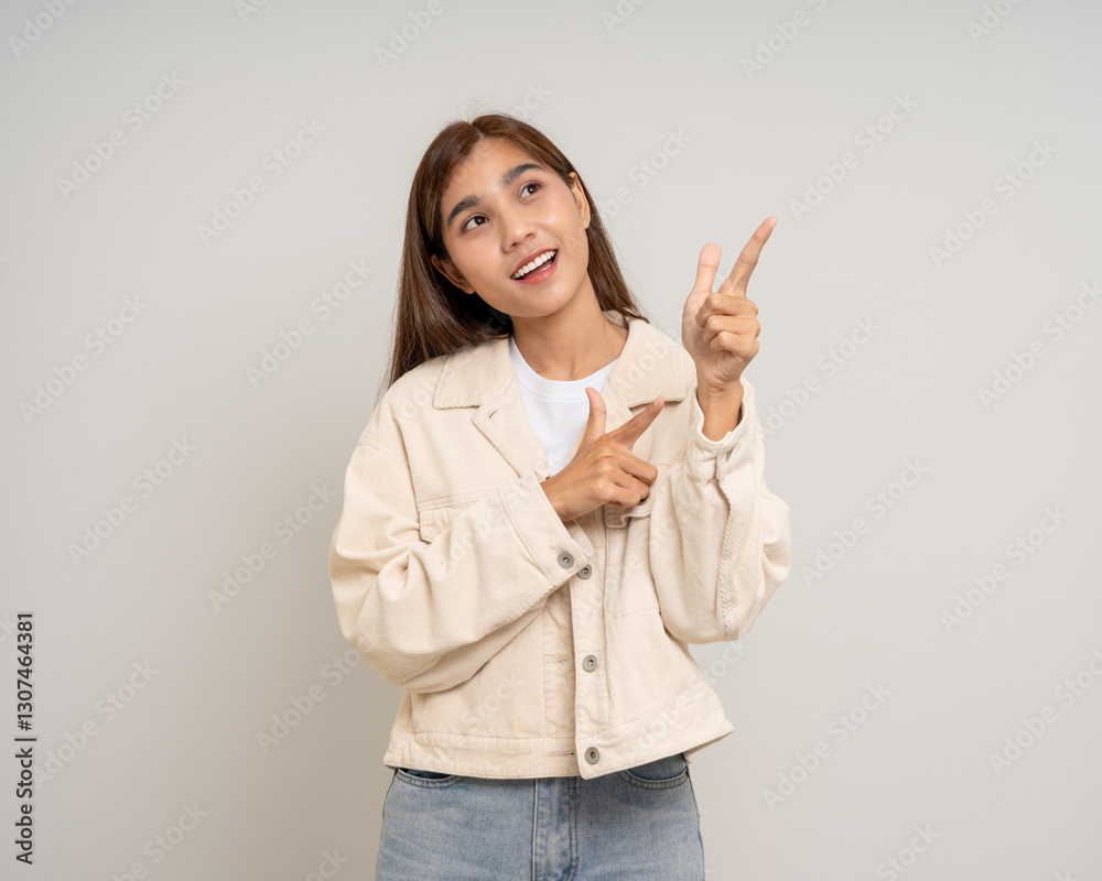 Beautiful smiling happy young asian woman. Charming female lady pointing finger to copy space on isolated white background. Asian woman cute Pretty people looking blank space. Beautiful smiling happy young asian woman. Charming female lady pointing finger to copy space on isolated white background. Asian woman cute Pretty people looking blank space.