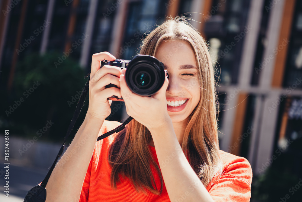 Charming young woman capturing moments with her camera outdoors in urban setting on a sunny day Charming young woman capturing moments with her camera outdoors in urban setting on a sunny day