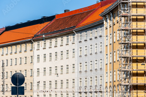 Colorful Helsinki buildings with red roofs on a bright day showcases the city's architecture.