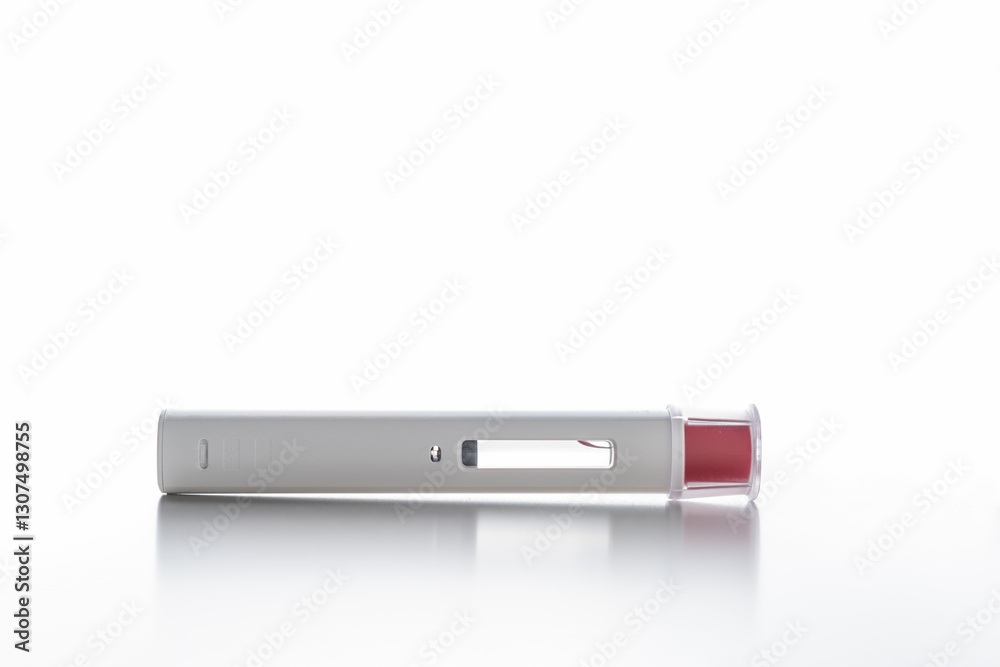 A white pen injector with a red tip for biological treatments such as Adalimumab, Etanercept or epinephrine. It is lying on a white light background, aseptic, clean, white and well lit. A white pen injector with a red tip for biological treatments such as Adalimumab, Etanercept or epinephrine. It is lying on a white light background, aseptic, clean, white and well lit.