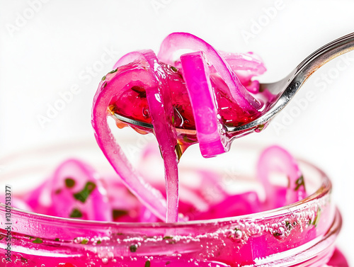 Fork lifting pickled red onions from jar.
