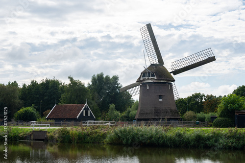 A windmill on the water in the Netherlands photo