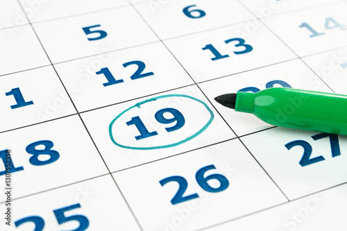 Marking date in a monthly planner.