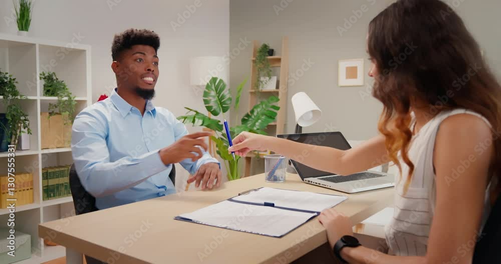 Happy businessman signing contract after successful job interview with human resources manager Happy businessman signing contract after successful job interview with human resources manager