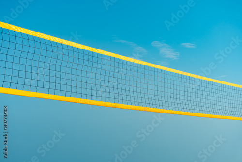 Beach volleyball court with blue summer sky, volleyball net, blue sky, outdoors