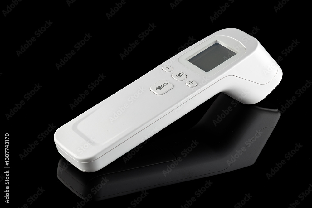 Digital medical infrared non contact thermometer gun for measuring temperature, isolated on black background. Close-up Digital medical infrared non contact thermometer gun for measuring temperature, isolated on black background. Close-up