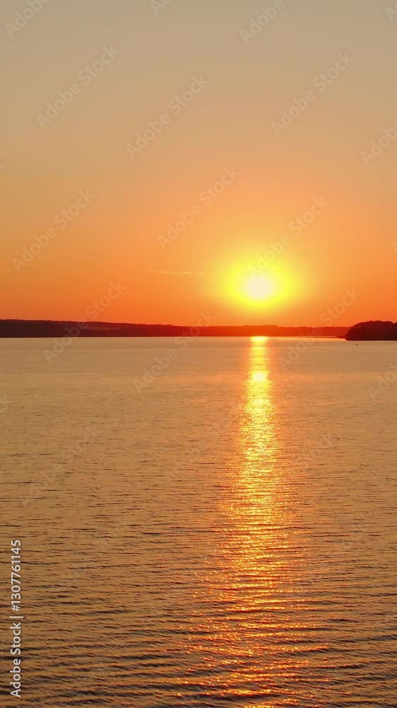Beautiful sunset on river. Dramatic sunset over the beautiful river. Vertical video Beautiful sunset on river. Dramatic sunset over the beautiful river. Vertical video