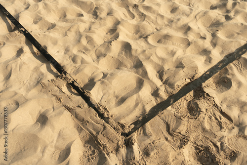 Black lines of beach volleyball in sand, summer, corner of volleyball court
