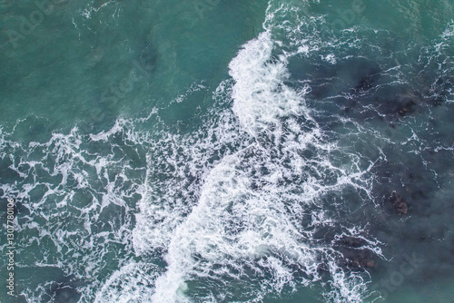 Aerial, Winter’s crashing tidal waves at Down Derry in Cornwall UK