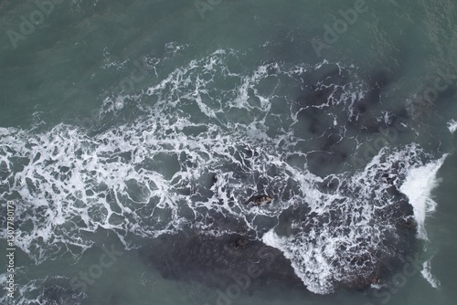 Aerial, Winter’s crashing tidal waves at Down Derry in Cornwall UK
